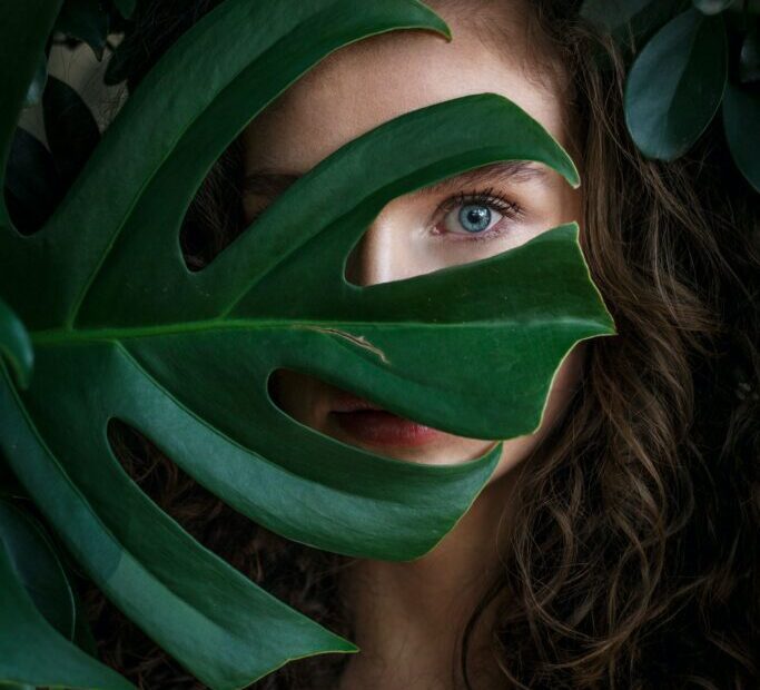 A girl peeping through the leaf